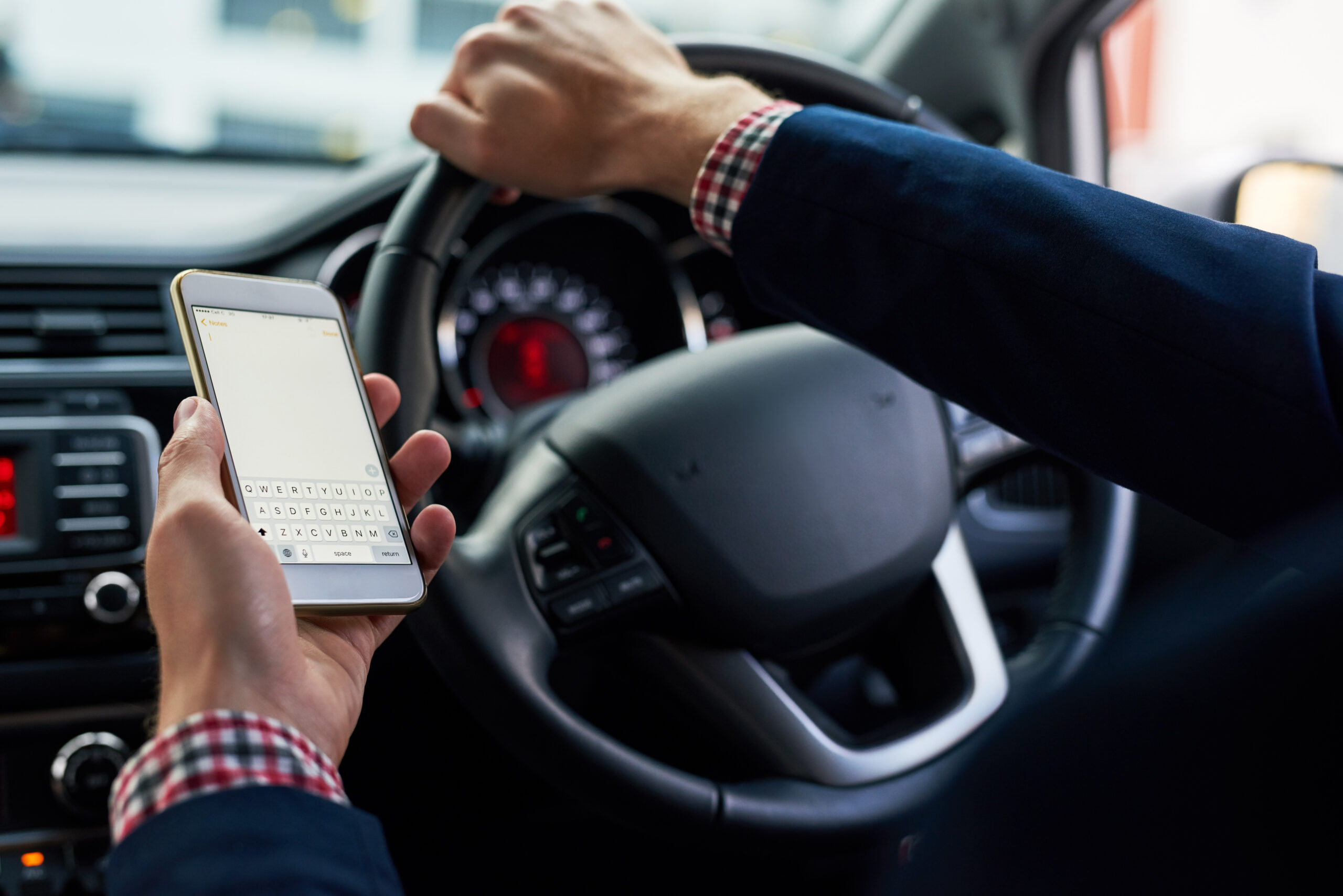Distracted driver texting behind the wheel
