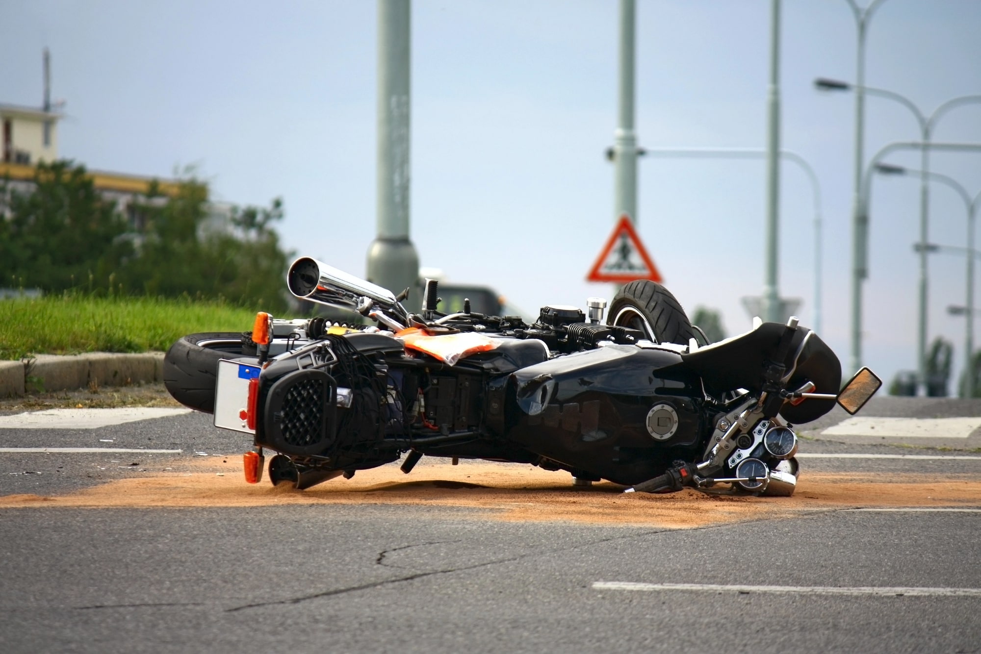 Damaged motorcycle lying on its side on a roadway in Morgantown, WV, after a crash.