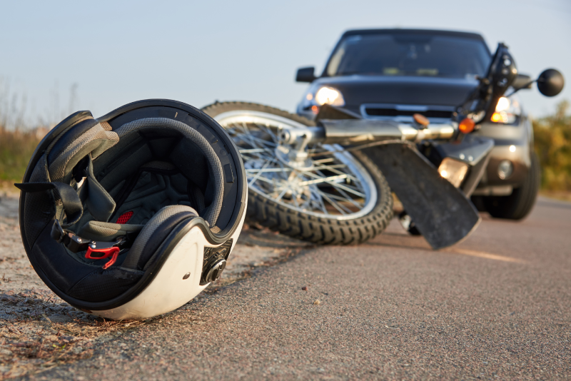 Motorcycle accident scene in Virginia Beach with fallen bike and helmet.