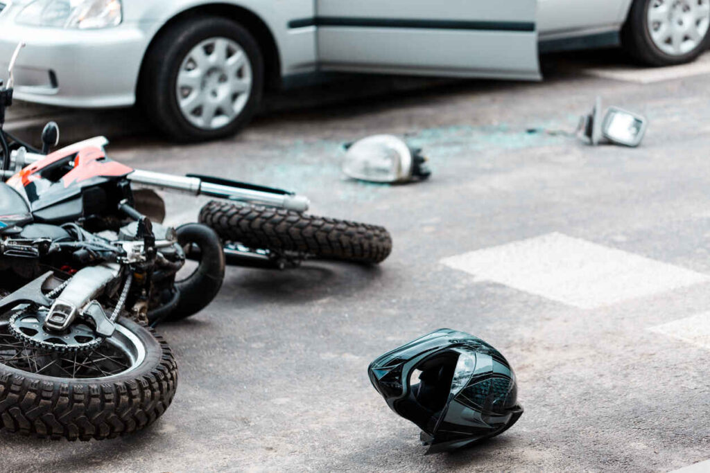 Black helmet and overturned motorcycle on the road after a Texas motorcycle accident.