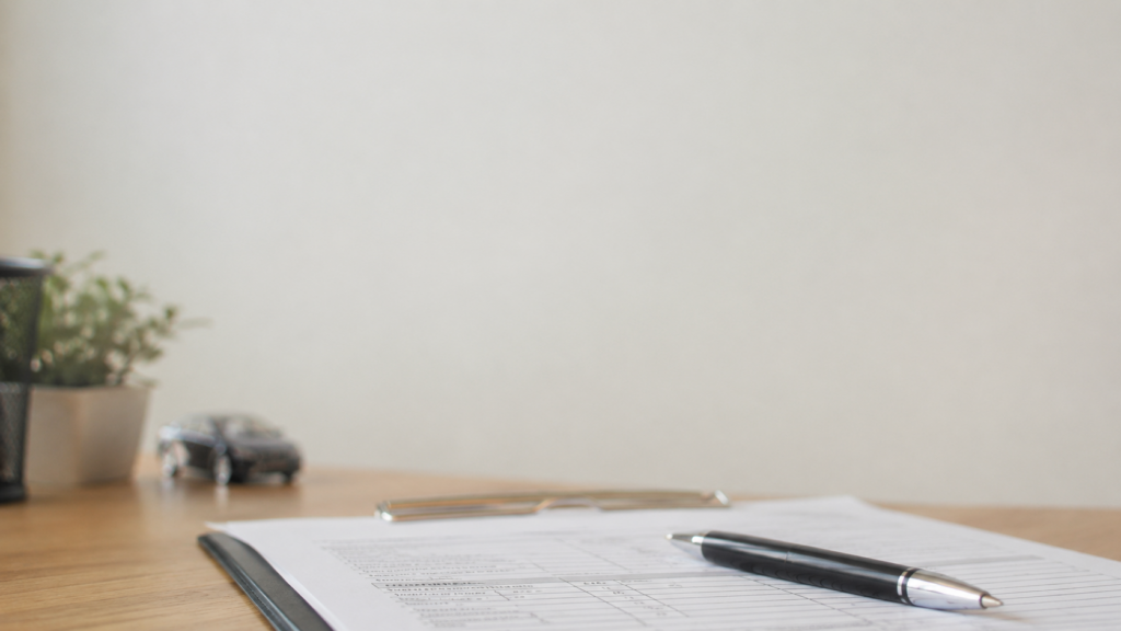 Car accident insurance claim form and pen on office desk, representing Maryland PIP coverage after a car accident