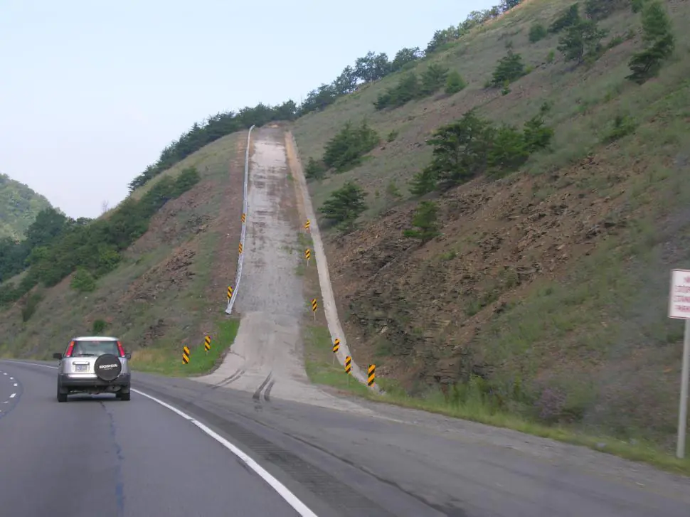 Runaway truck ramp accident prevention: steep uphill escape ramp beside a West Virginia mountain highway